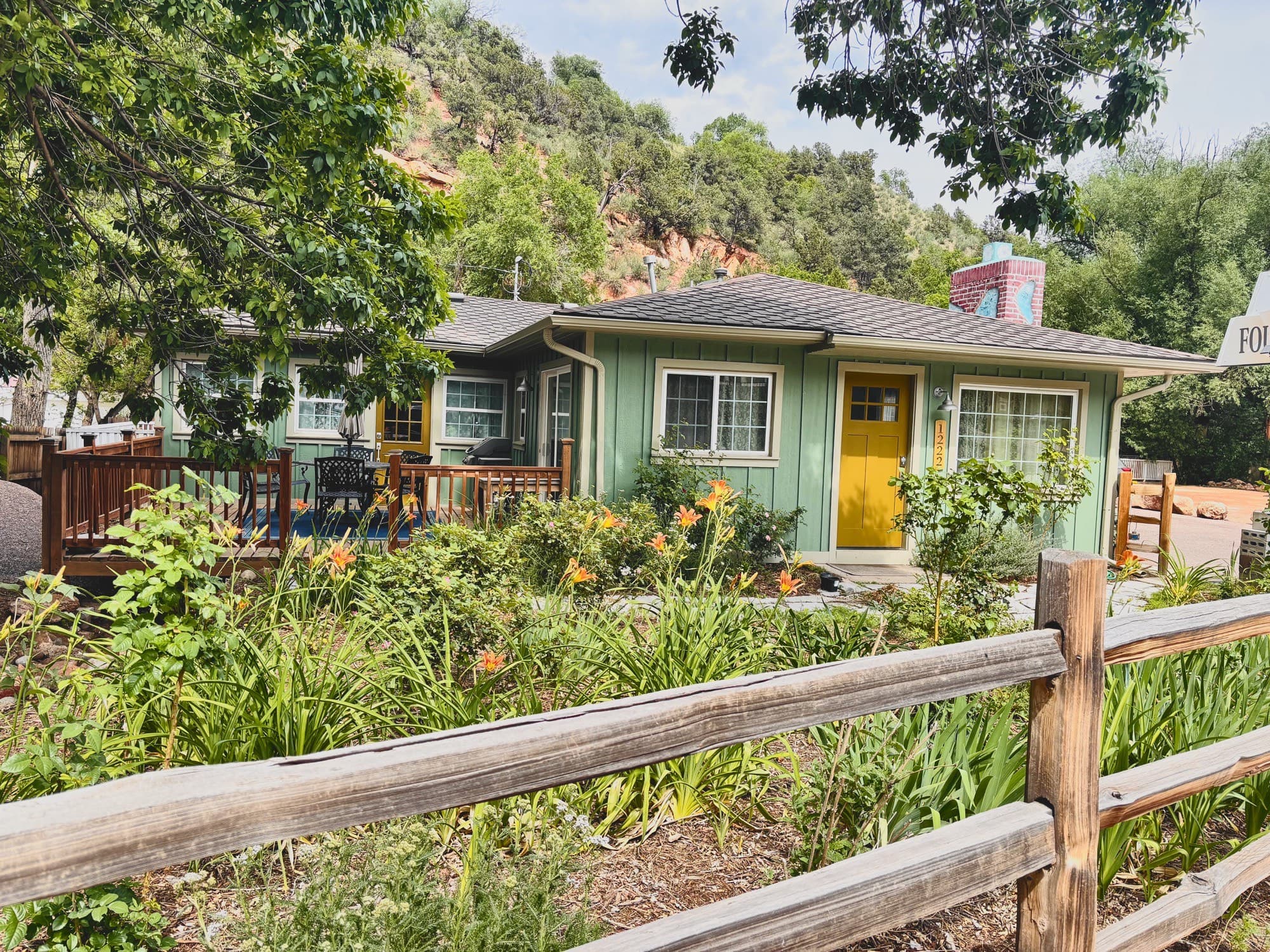 The Fountain Creek Inn's garden house at the quiet end of Manitou Avenue, the creek and pines beside it
