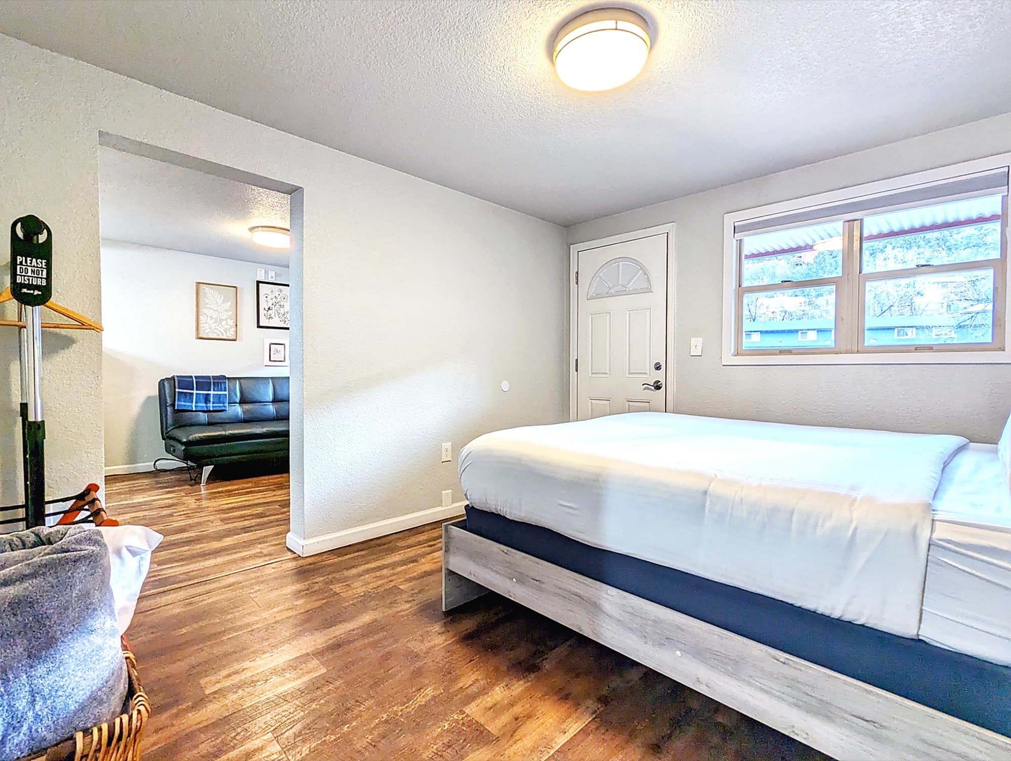 The suite's bedroom opening to a sitting area, with a window to the rocks